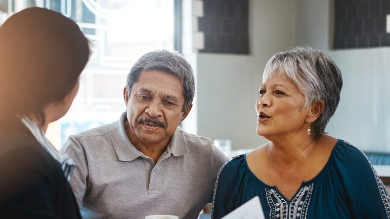 Senior couple, talking and lawyer with documents for financial advice, retirement plan and will at home. Old man, elderly woman and attorney with paperwork, budget negotiation and legal agreement