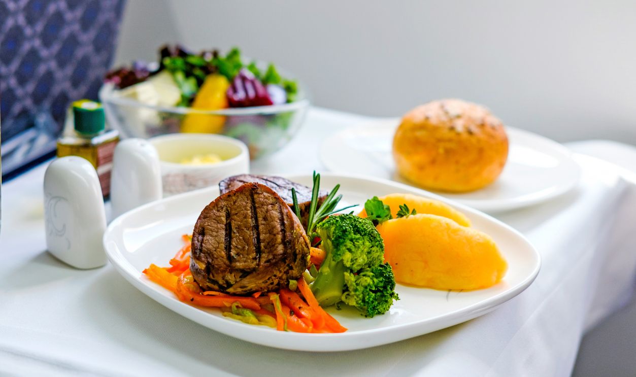 Tasty meal served on board of airplane on the table