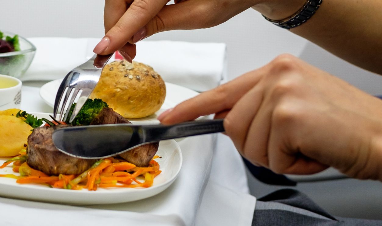 Woman eating lunch in airplane