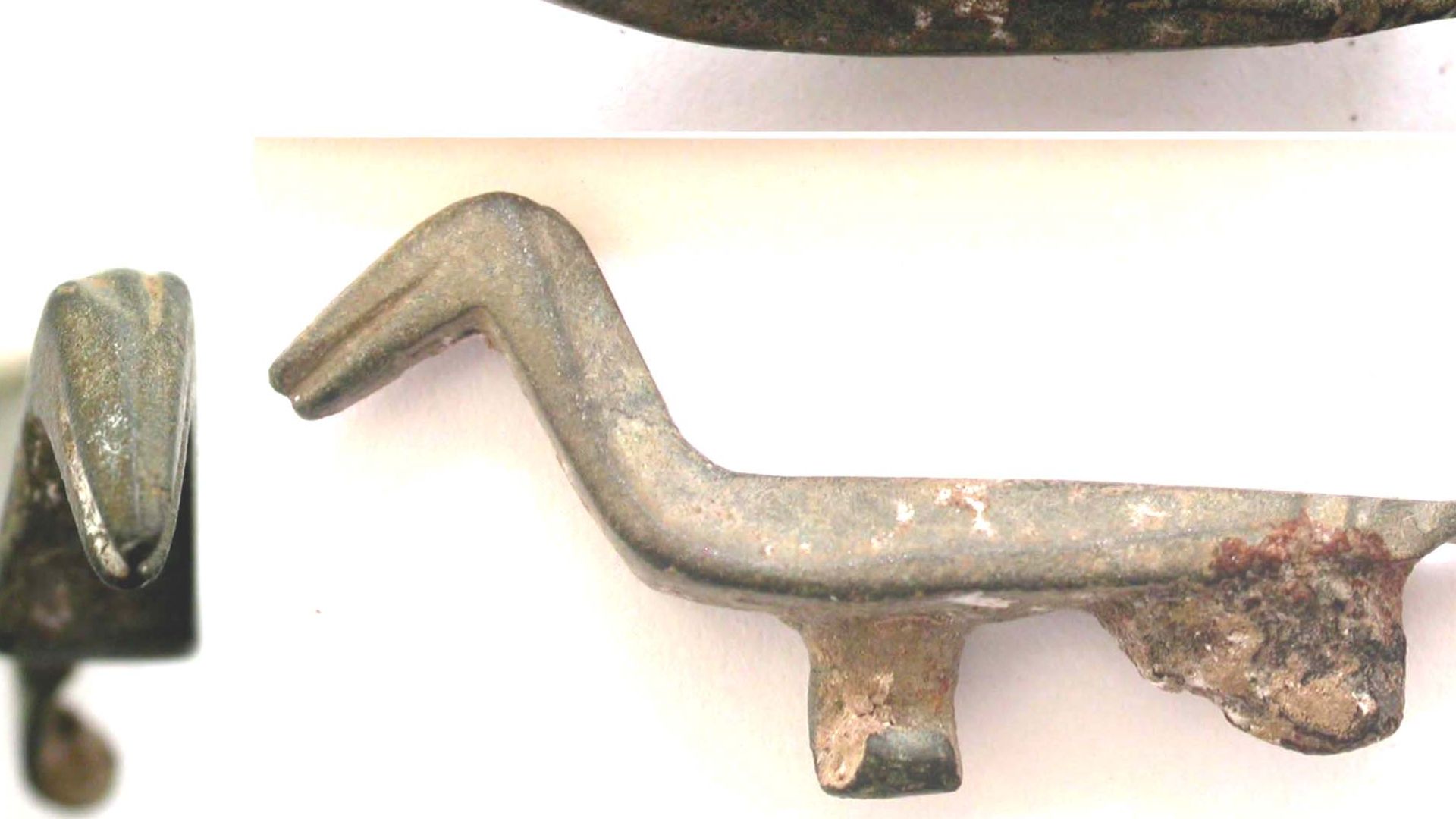 A Roman copper alloy zoomorphic brooch in the form of a bird (duck) (2nd century).  The body is shaped by three longitudinal facets, one along the back and one on each side.  The beak and is defined by an incised line on each side and the crest is similar