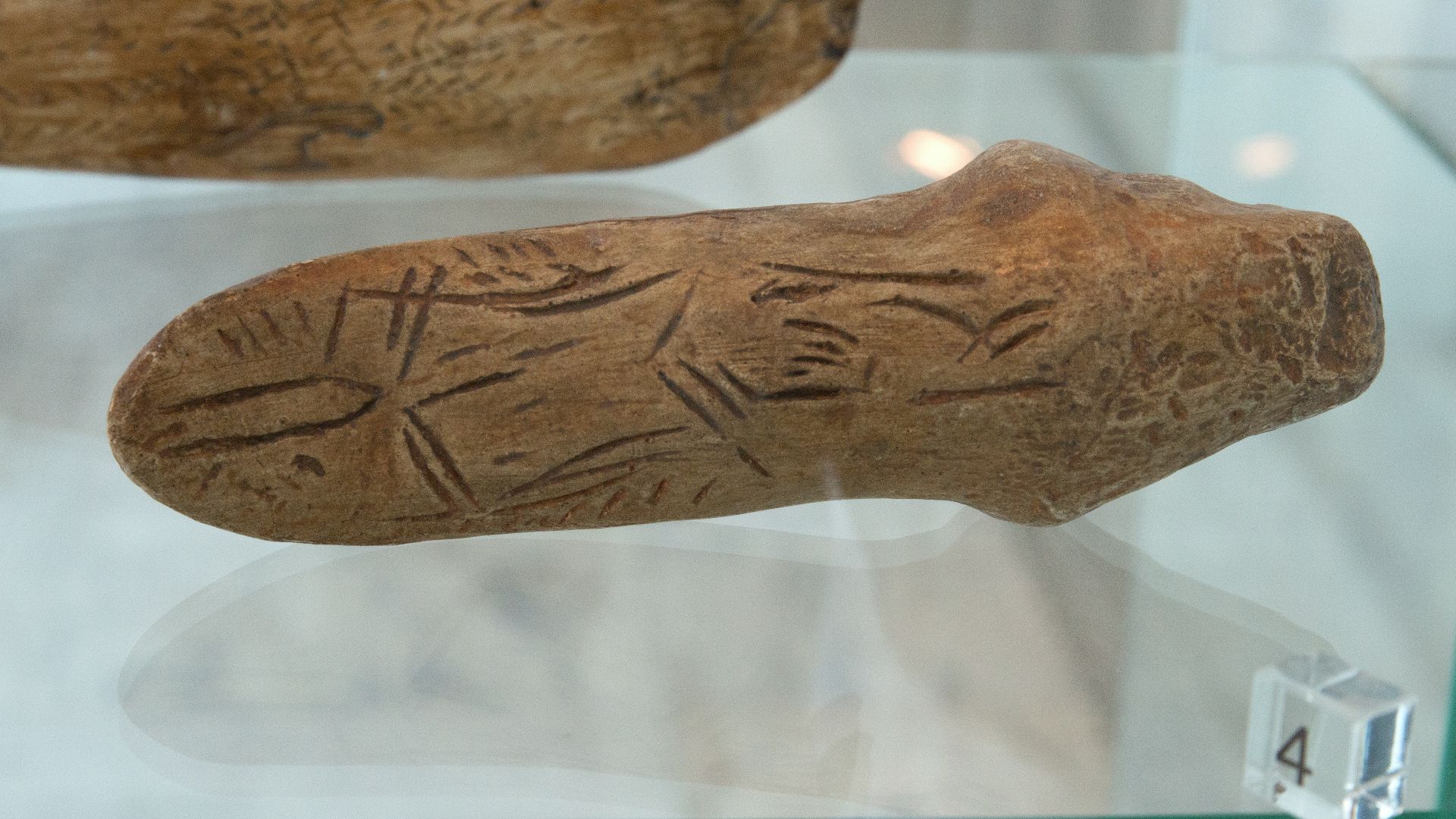 Upper Paleolithic art: (4) Extremely stylized sculpture of woman (?) from Mezin (Ukraine). Anthropos Pavilon, Brno.