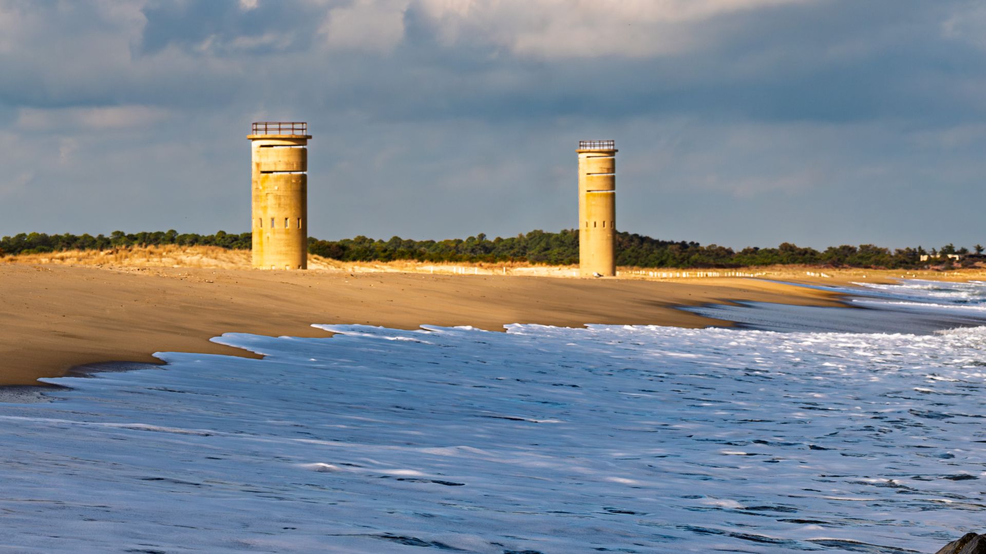 The beach at Cape Henlopen was quiet in that late November way. Wide sand, heavy clouds, and the Atlantic rolling in without much interest in being welcoming. The two WWII fire control towers sat back from the water, solid and unchanged, looking out over 