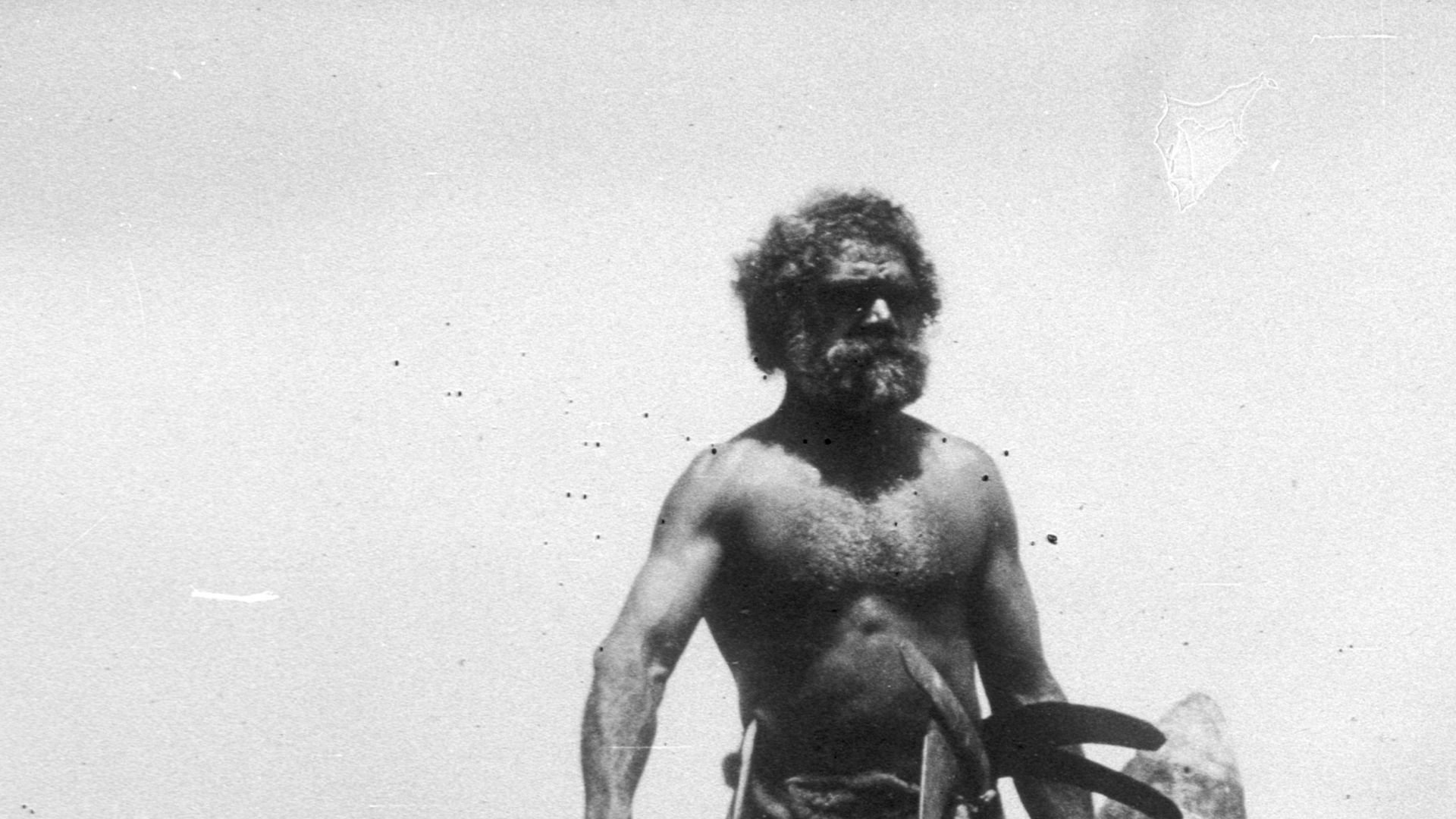 Aboriginal man with painted shield, boomerangs and dead snake, New South Wales, Australia. Photographed by Thomas Dick ca. 1905