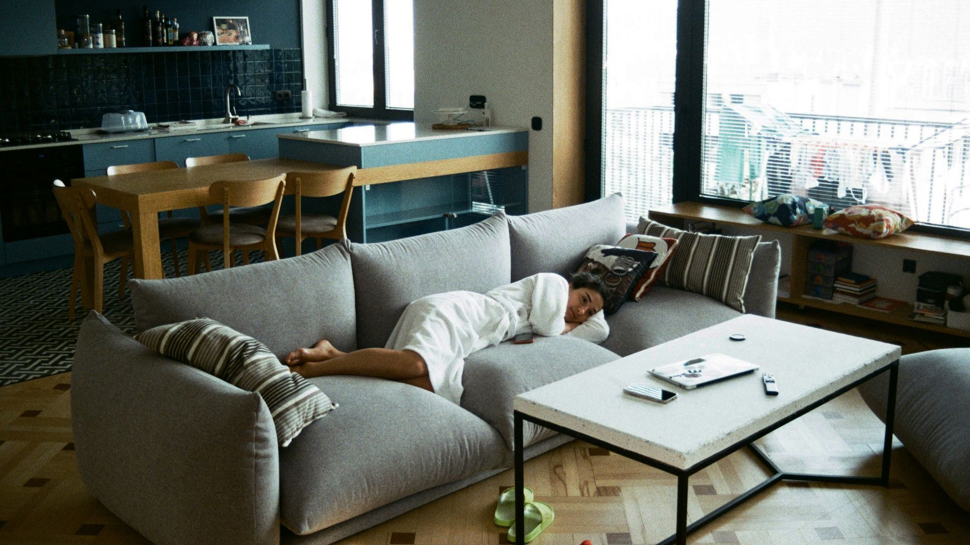 a man laying on a couch in a living room