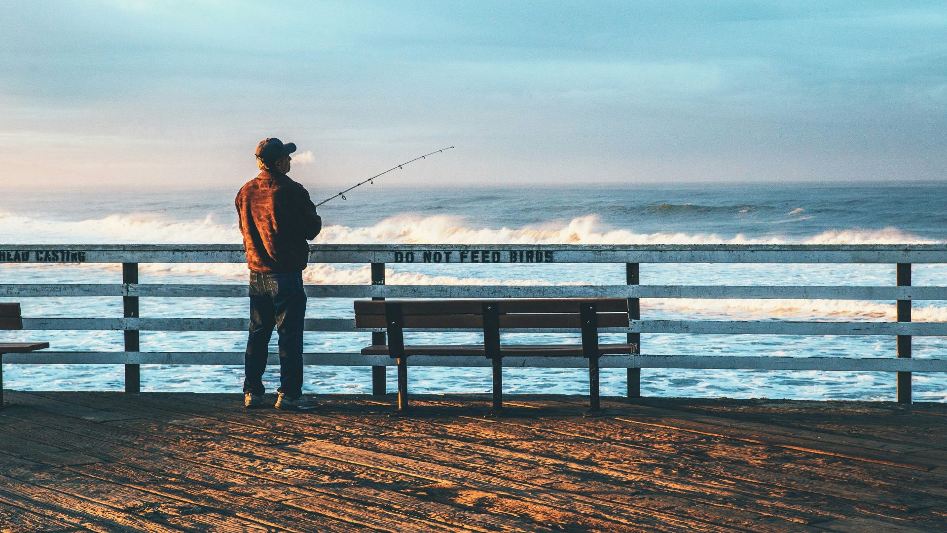 man fishing on seaside