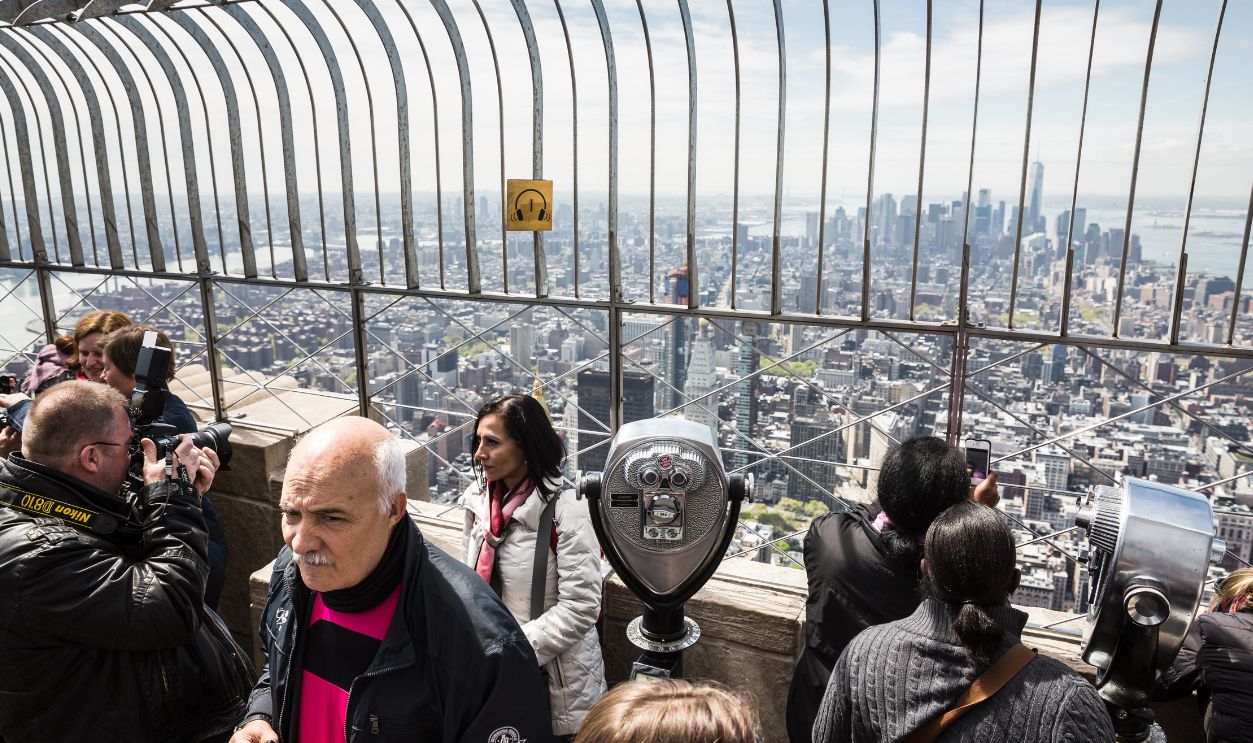 NEW YORK, USA - Apr 30, 2016: Tourists enjoying the breathtaking views of New York City from the observation deck of Empire State Building