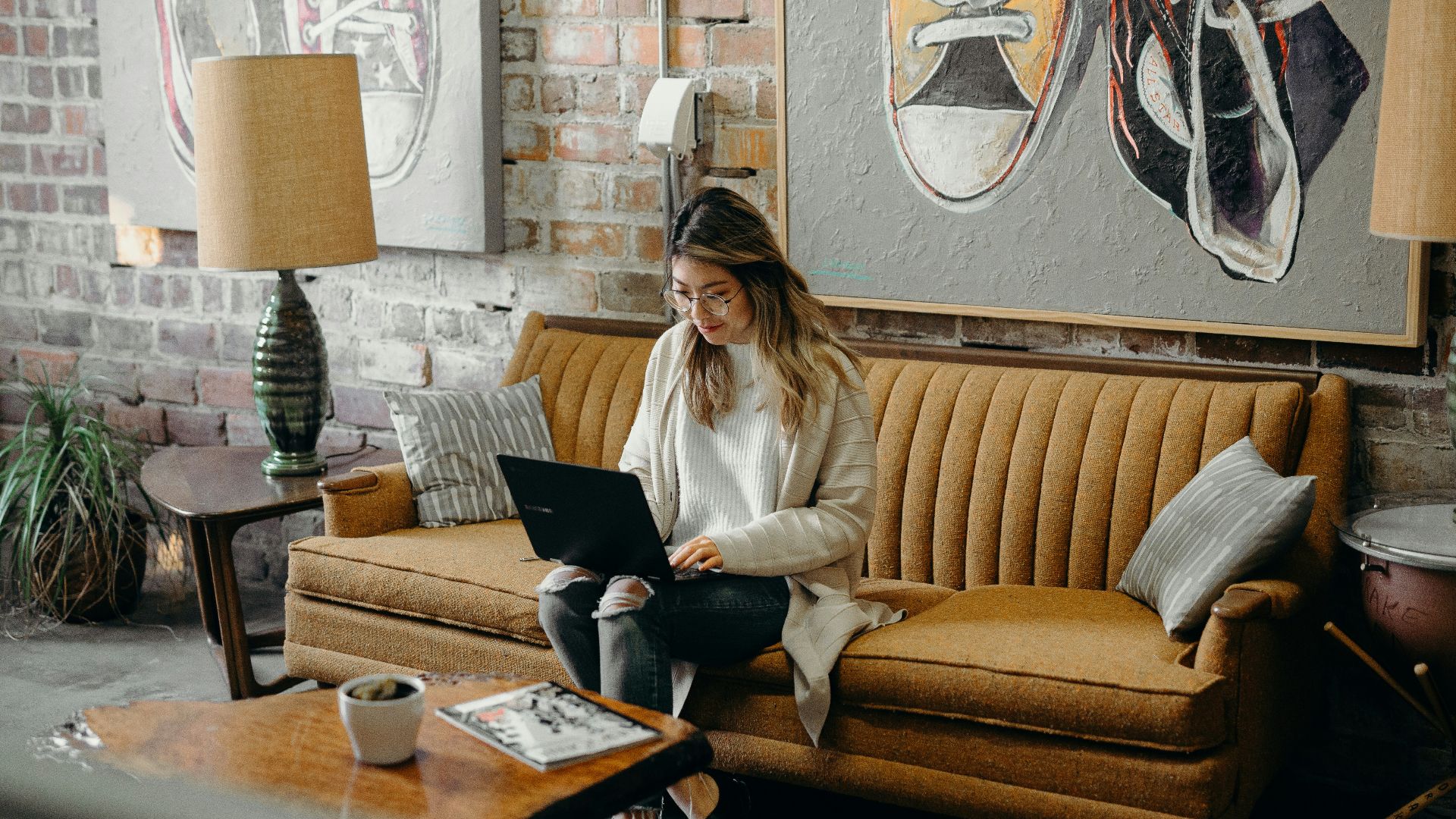 woman using laptop while sitting on chair