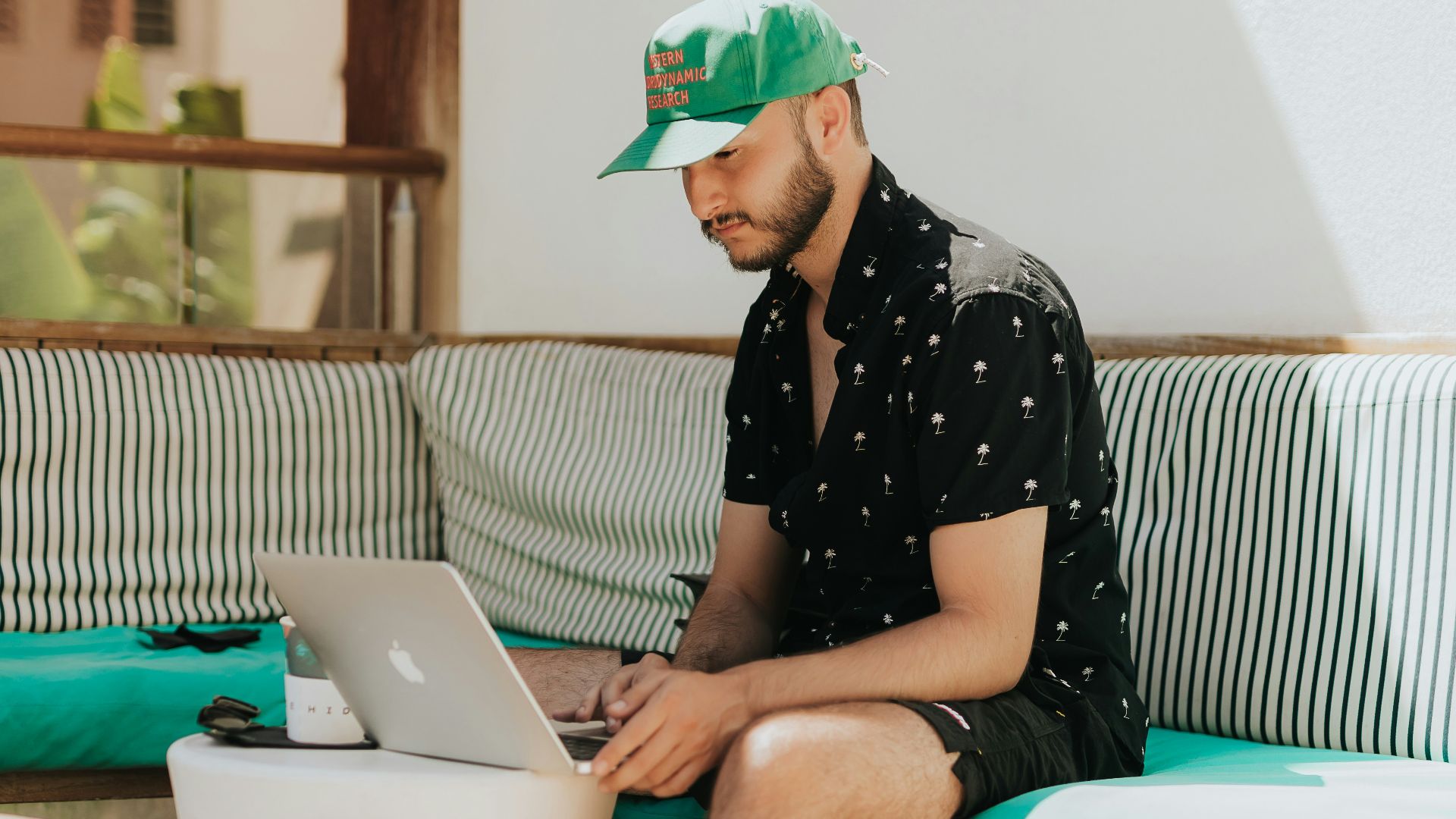 a person sitting on a couch using a laptop