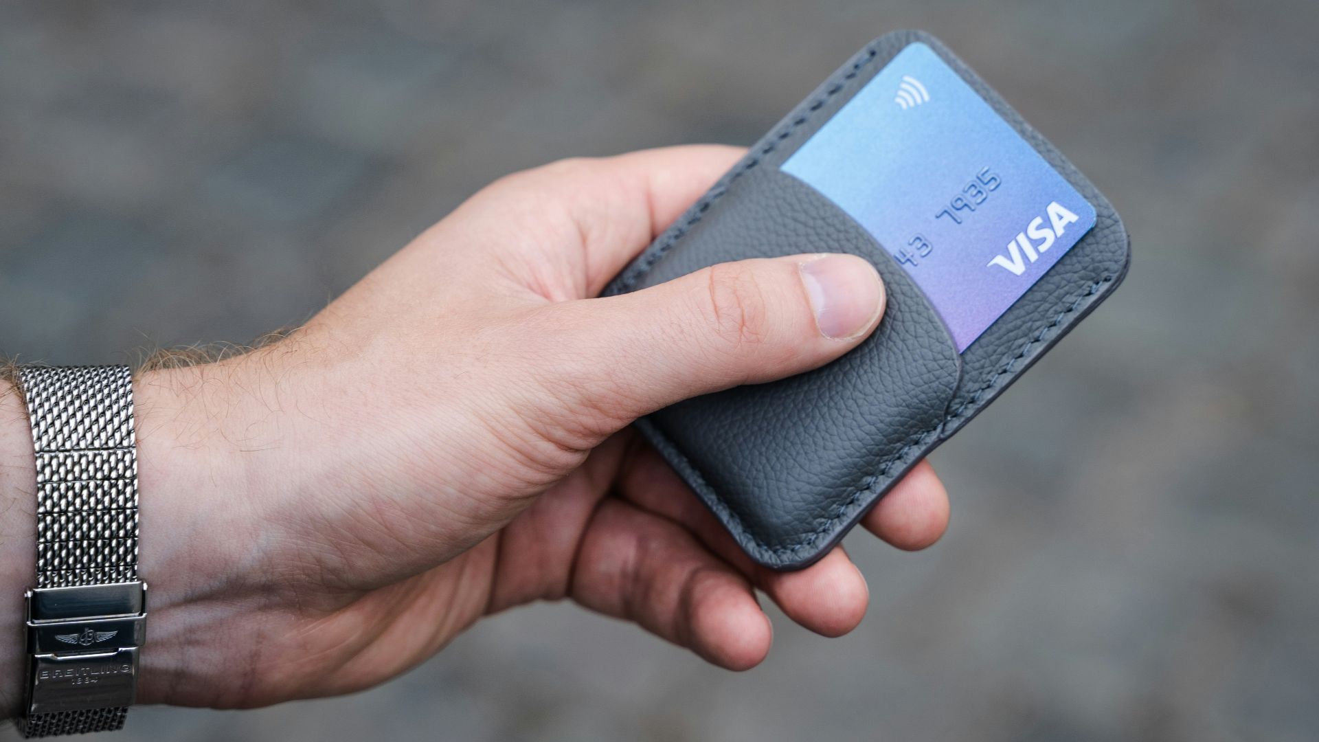 a person holding a credit card in their hand