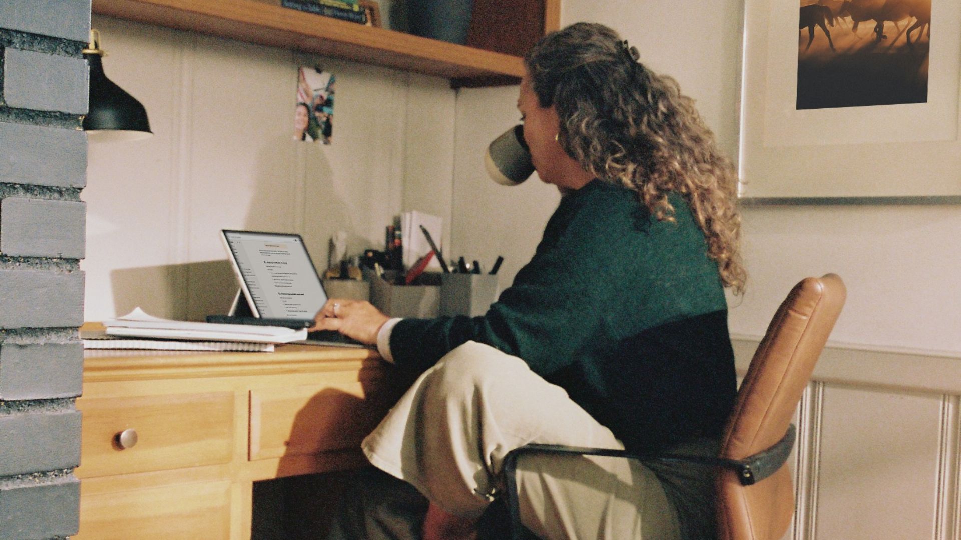 Woman working at desk with coffee