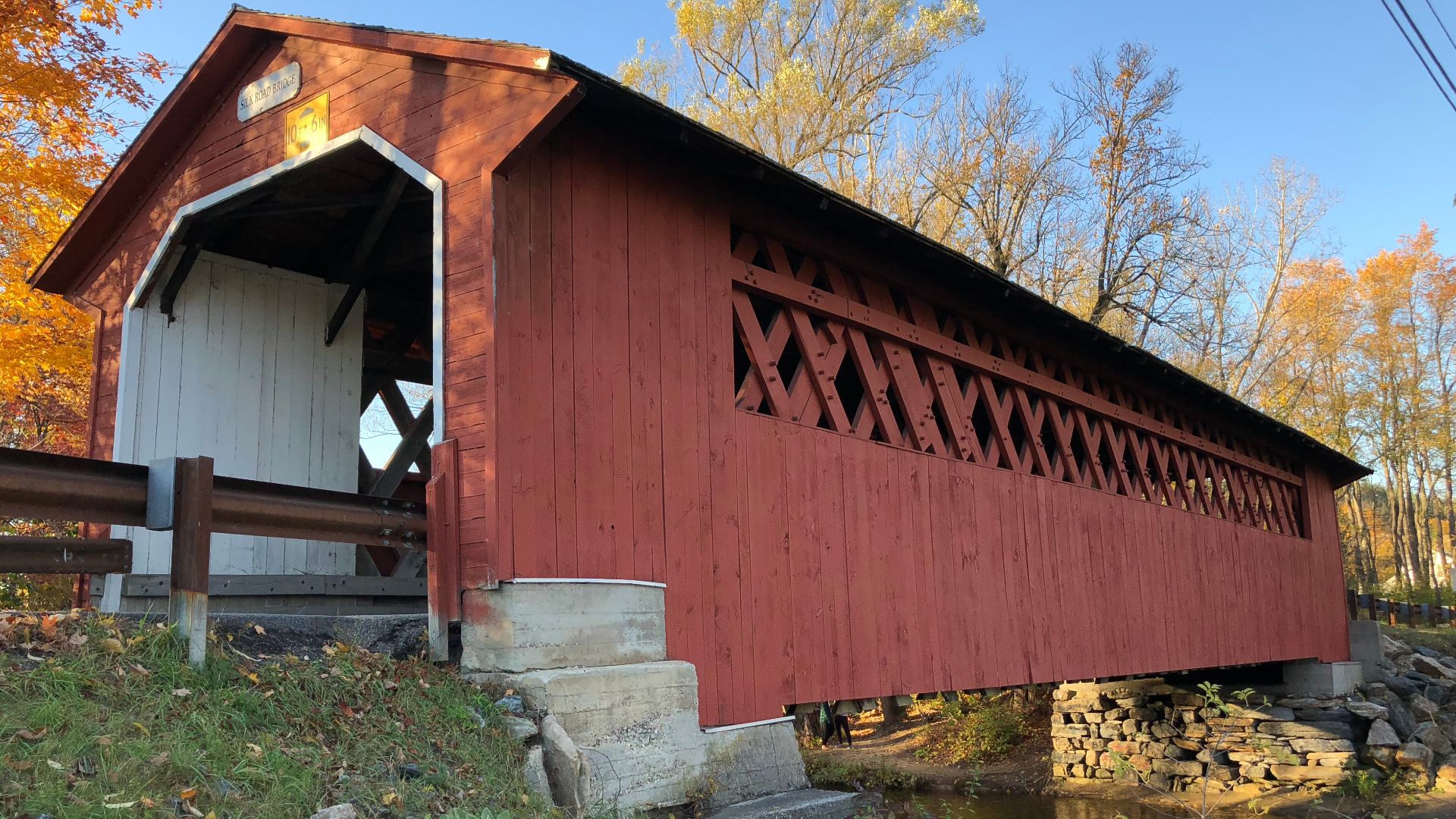 View of the east side of the Silk Road Covered Bridge from the south bank of the Walloomsac River in Bennington, Bennington County, Vermont