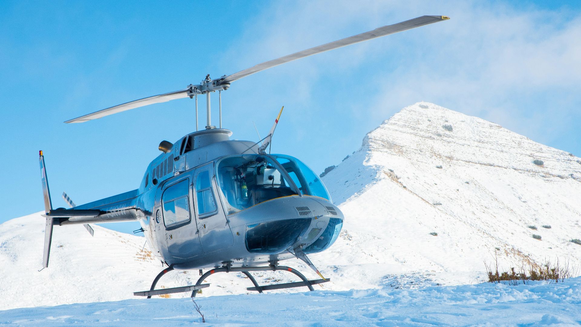 gray helicopter on mountain