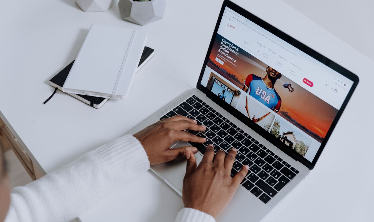 Close-up of hands typing on a laptop in a modern workspace. Minimalist, clean aesthetic