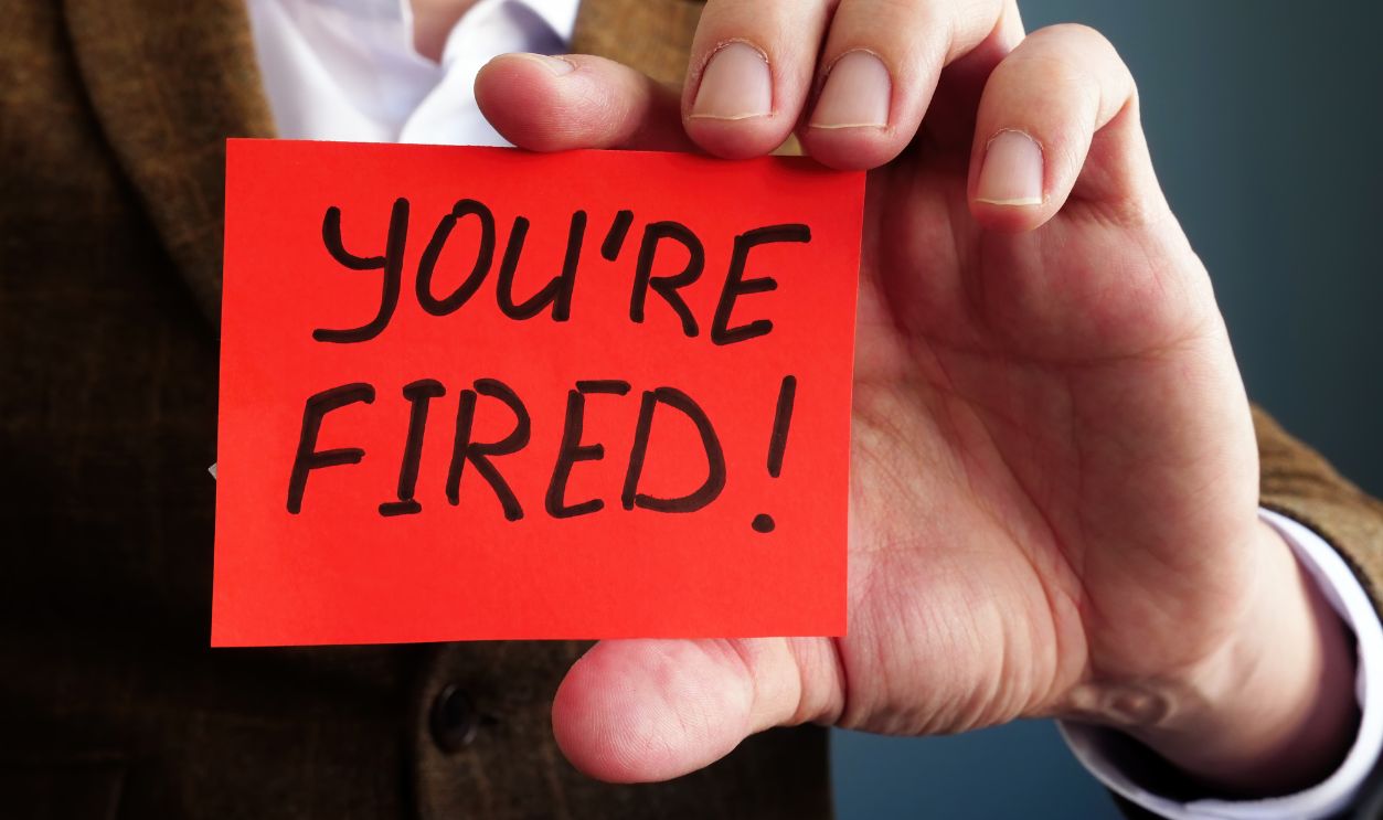 Employer shows phrase You are fired. Wrongful Dismissal concept.