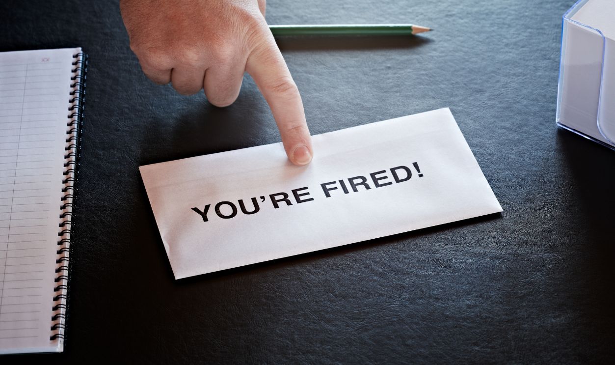 finger pointing at letter on office desk