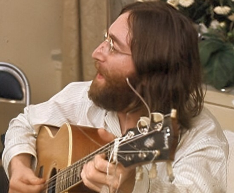 John Lennon playing a guitar