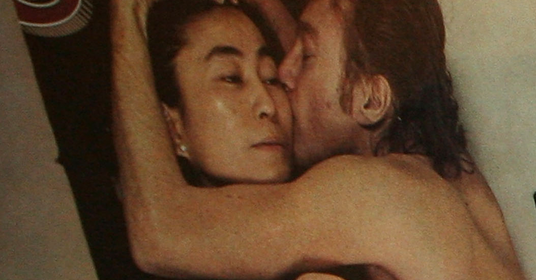 Photographer Annie Leibovitz autographs her iconic Rolling Stone cover photo featuring John Lennon and Yoko Ono