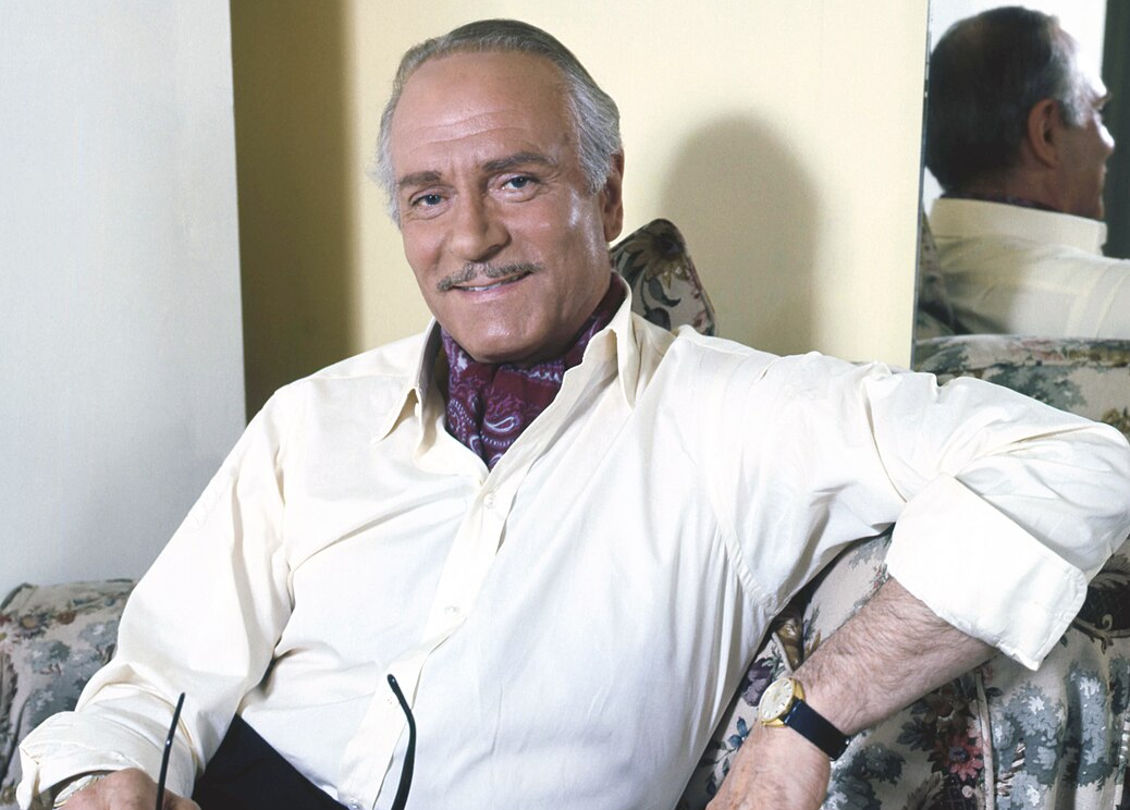 Laurence Olivier posing on a couch in 1972