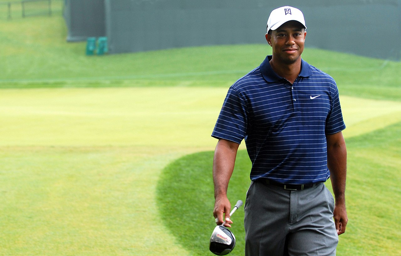 Tiger Woods smiling in blue t-shirt