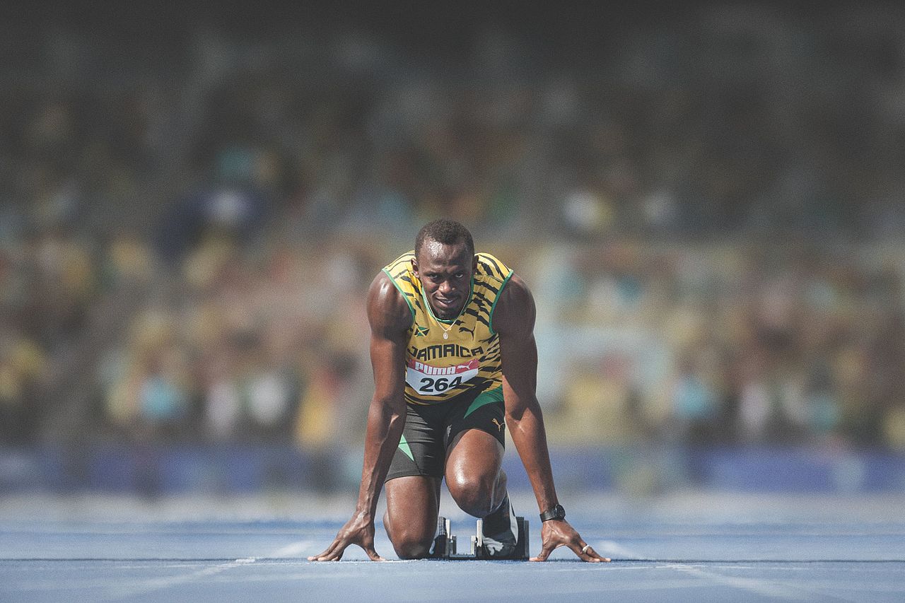 Usain Bolt at the start of a race in 2014