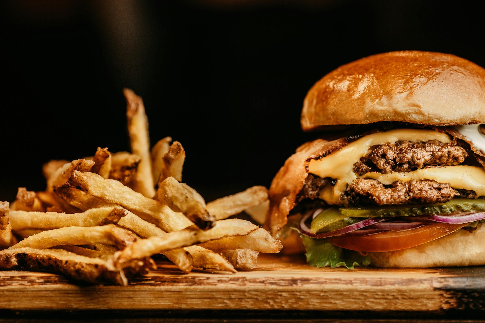 hamburger and fries image on a wooden table
