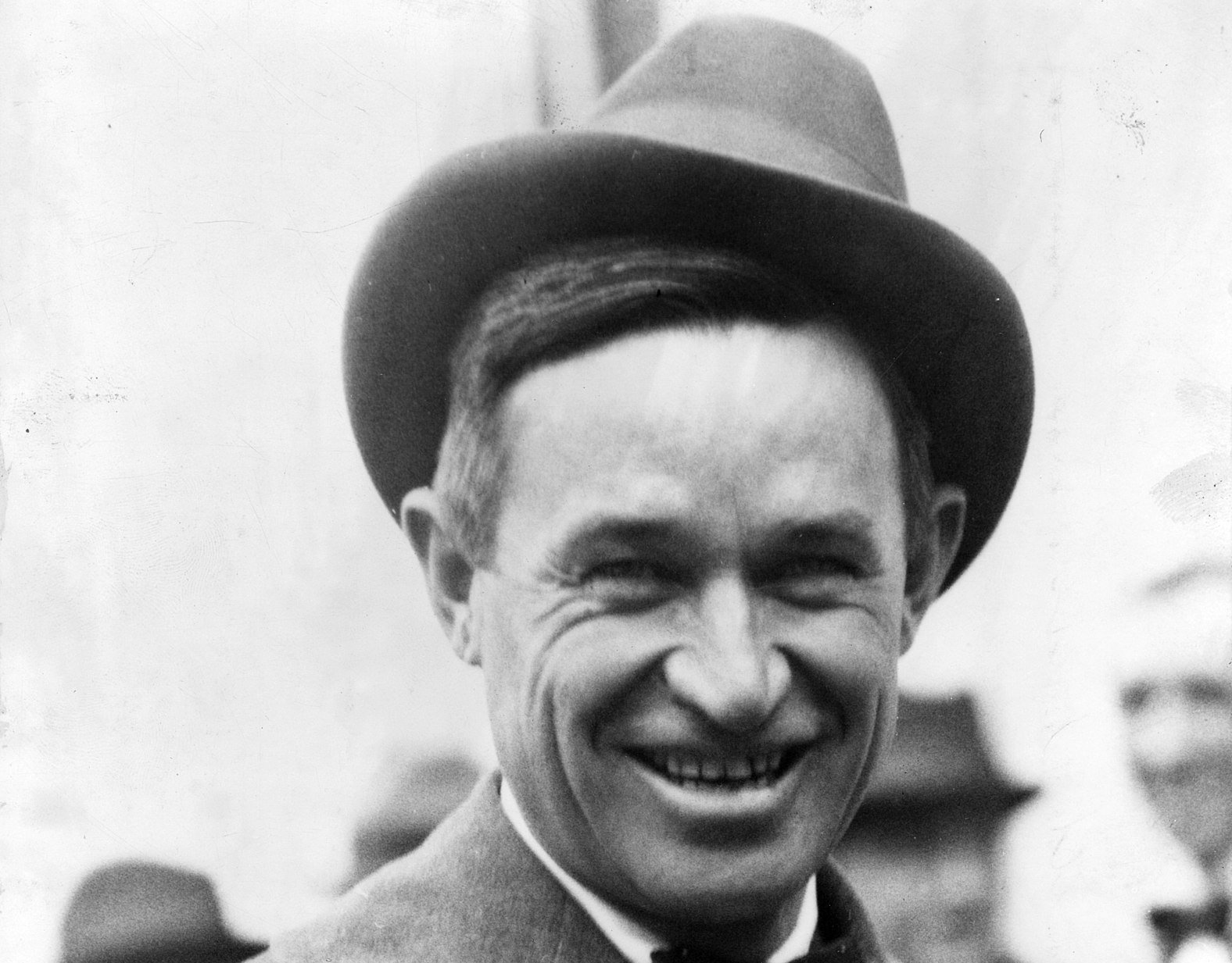 Grayscale Portrait Photo of Will Rogers in a gray suit an hat