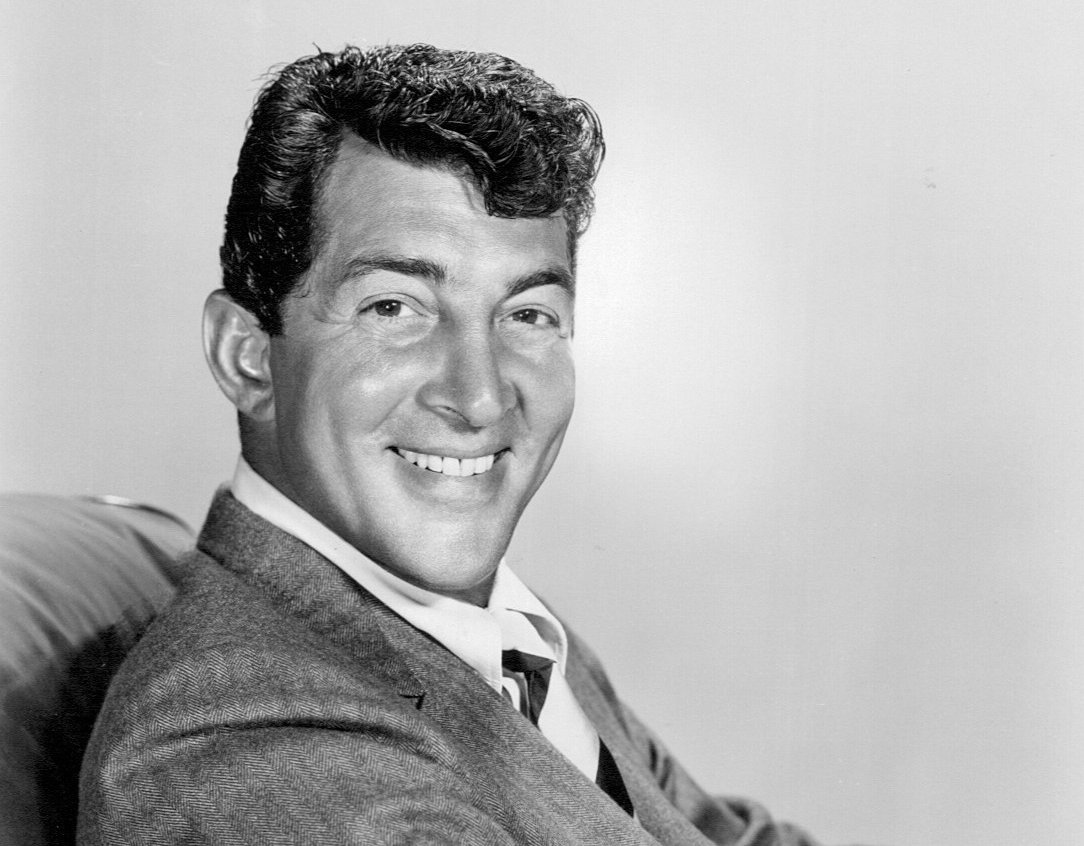 Grayscale Portrait Photo of Dean Martin in a gray suit