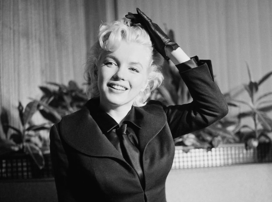 American actress Marilyn Monroe (1926 - 1962) in an airport waiting room