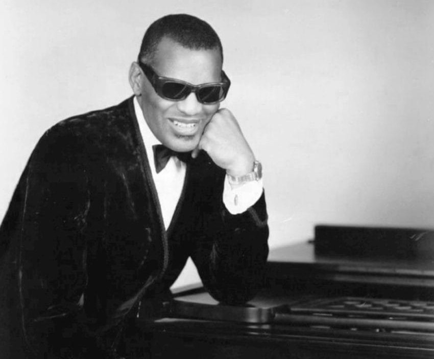 Grayscale Portrait Photo of Photo of Ray Charles wearing dak suit