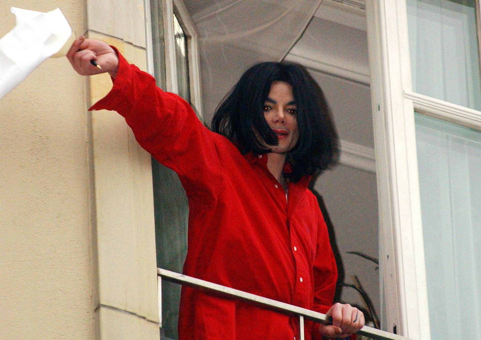 Singer Michael Jackson appears at the balcony of the Adlon Hotel November 19, 2002