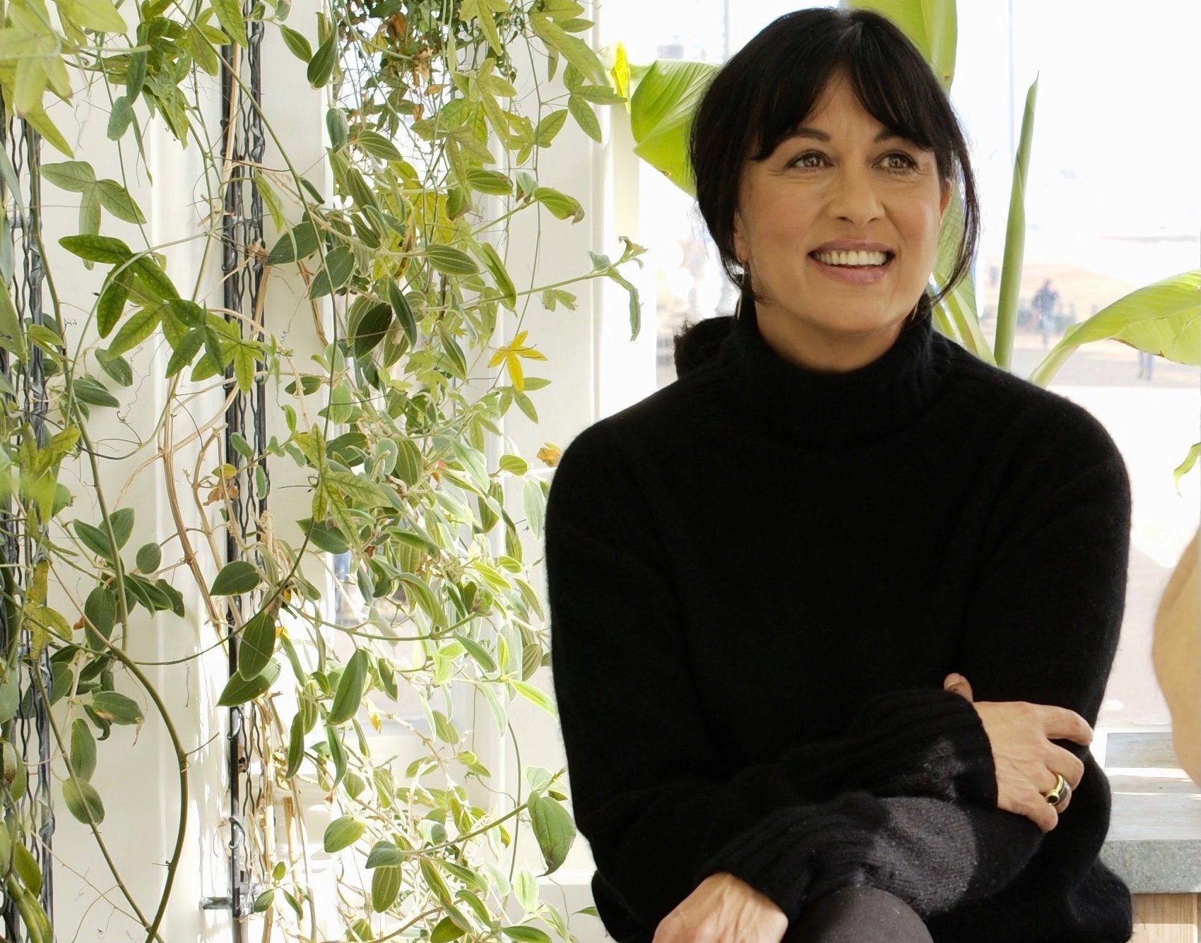 A photograph of the author and lyricist Polly Samson in dark outfit