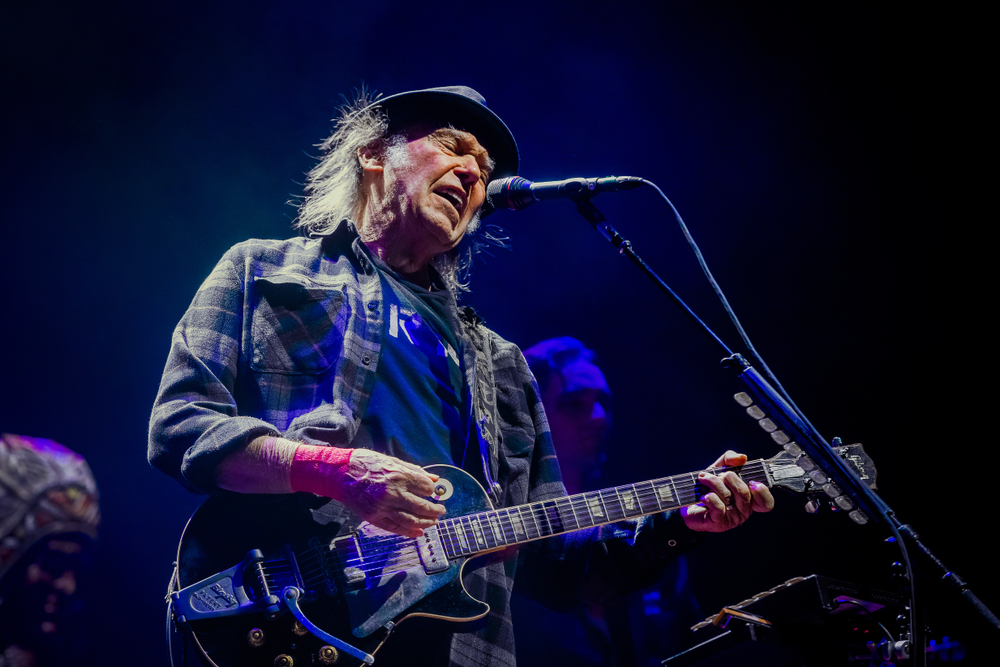 Portrait Photo of Neil Young Performing on Stage