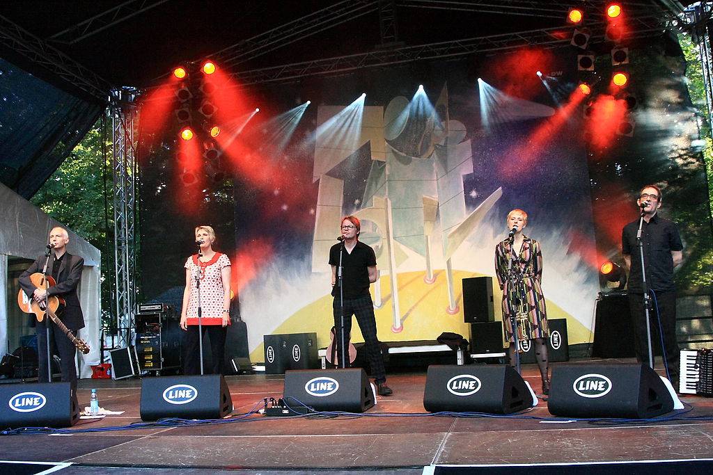 Members of  the band Chumbawamba perform on stage