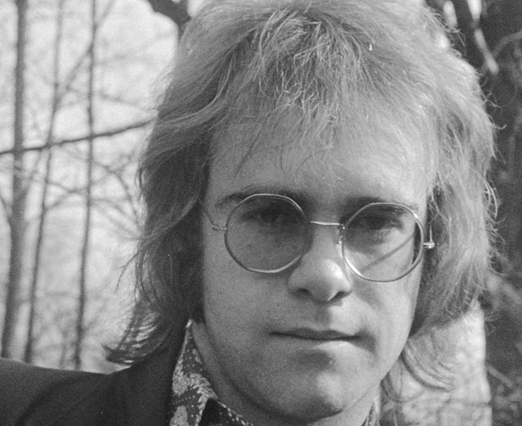Grayscale Portrait Photo of British singer Elton John