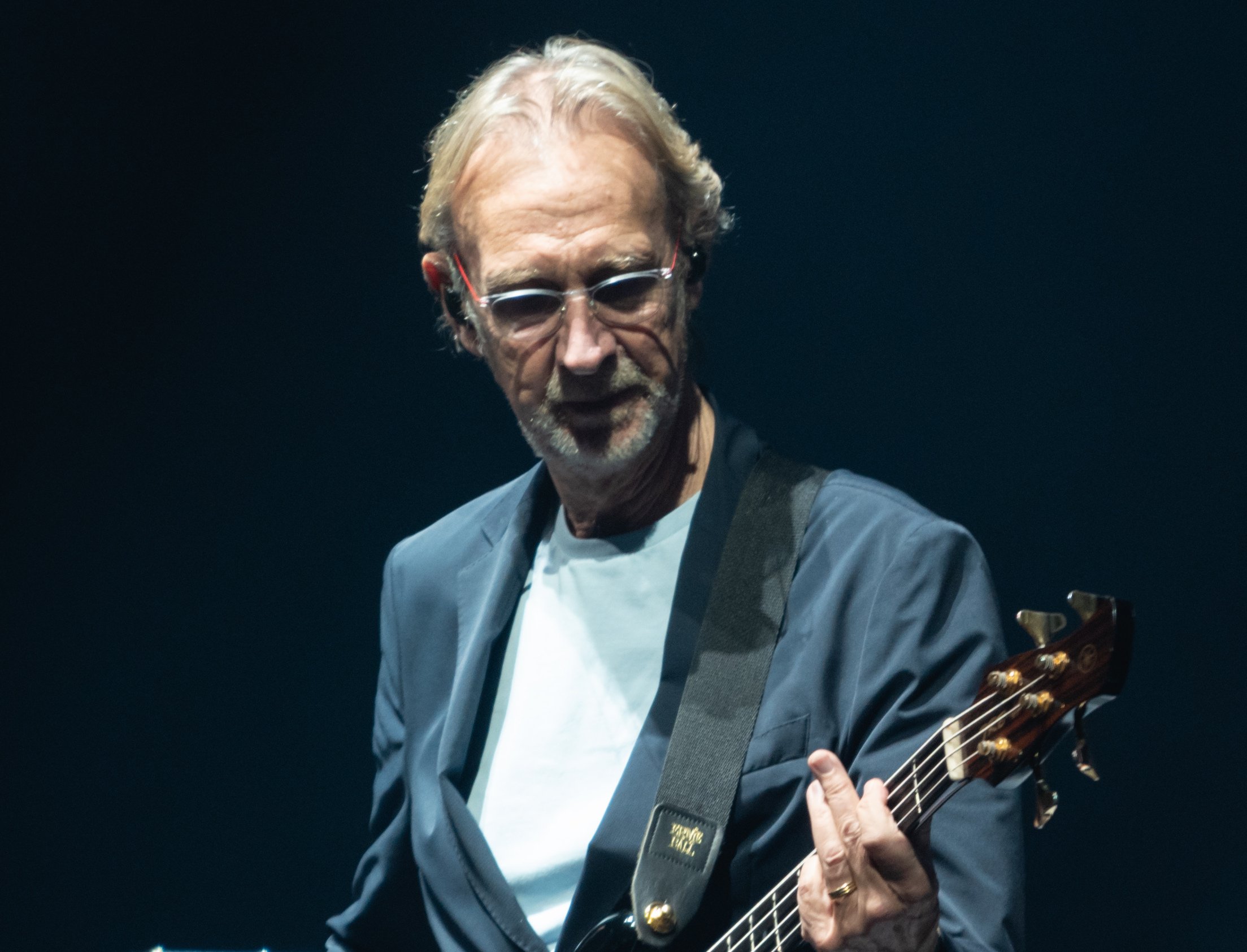 Portrait Photo of Mike Rutherford playing on stage