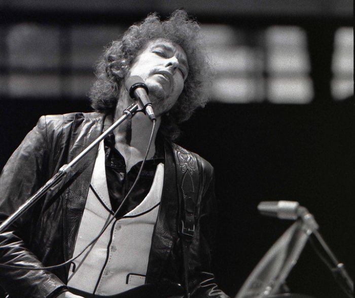 Grayscale Portrait Photo of Bob Dylan performing on stage in Rotterdam