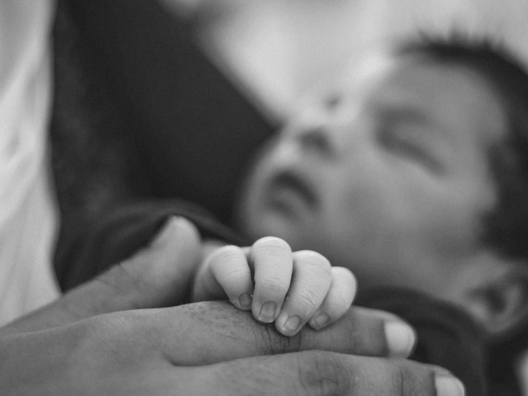 a man holding a baby in his arms