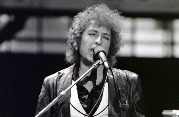 Grayscale Portrait Photo of Bob Dylan Performing on stage in Rotterdam