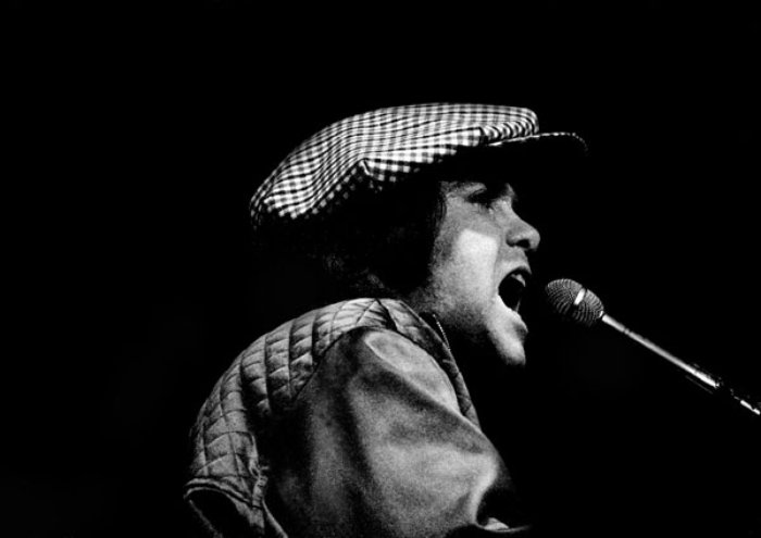 Grayscale Portrait Photo of Elton John performing live in concert