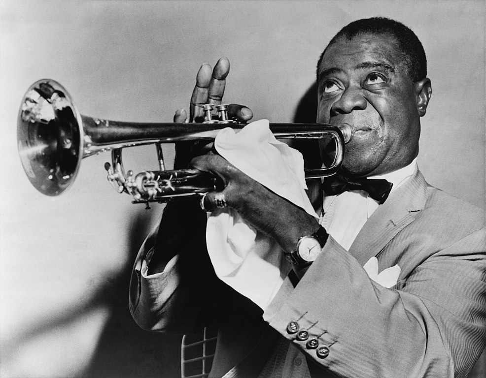 American trumpeter and vocalist Louis Armstrong playing his trumpet