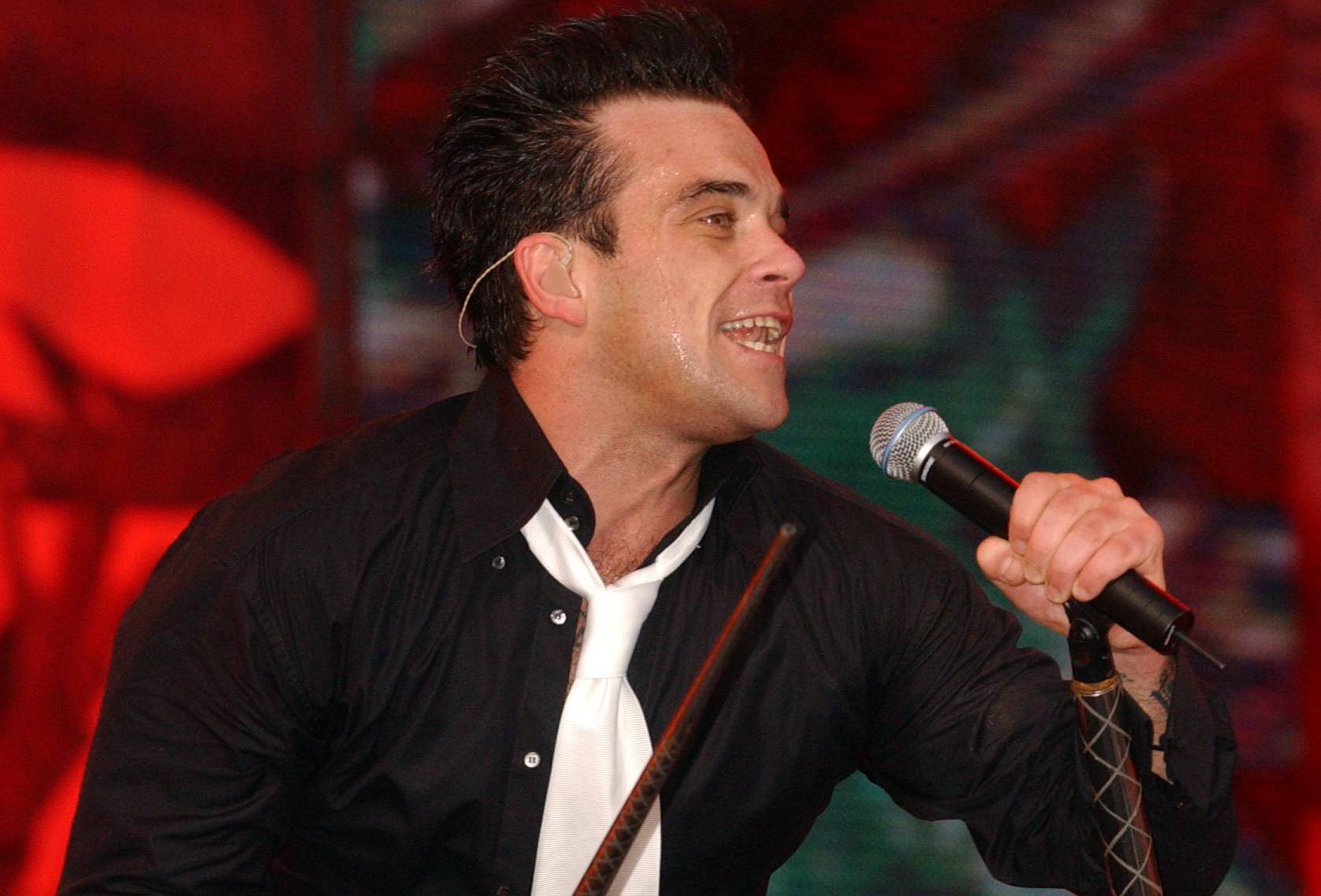 Singer Robbie Williams performs the first of three sold-out shows at rock venue Knebworth Park