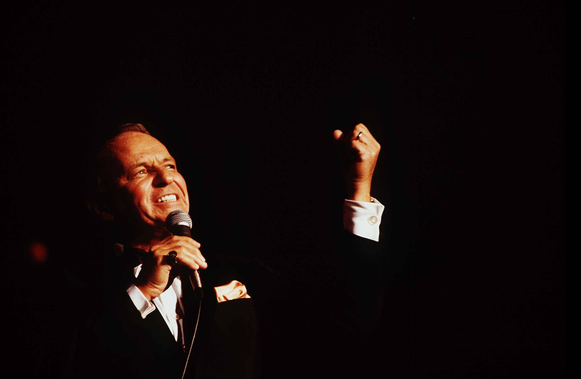 Frank Sinatra performs on stage.