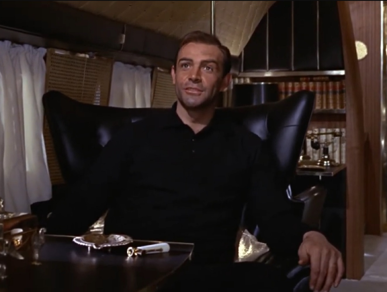 Screenshot of Sean Connery seating - from Goldfinger (1964)