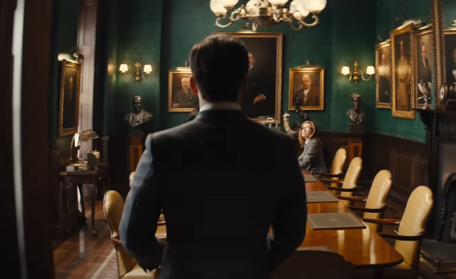 Man entering the room full of paintings