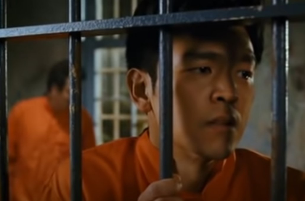 Man in prison behind the jars