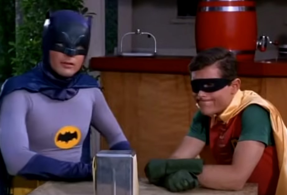 image of batman and robin sitting in a restaurant
