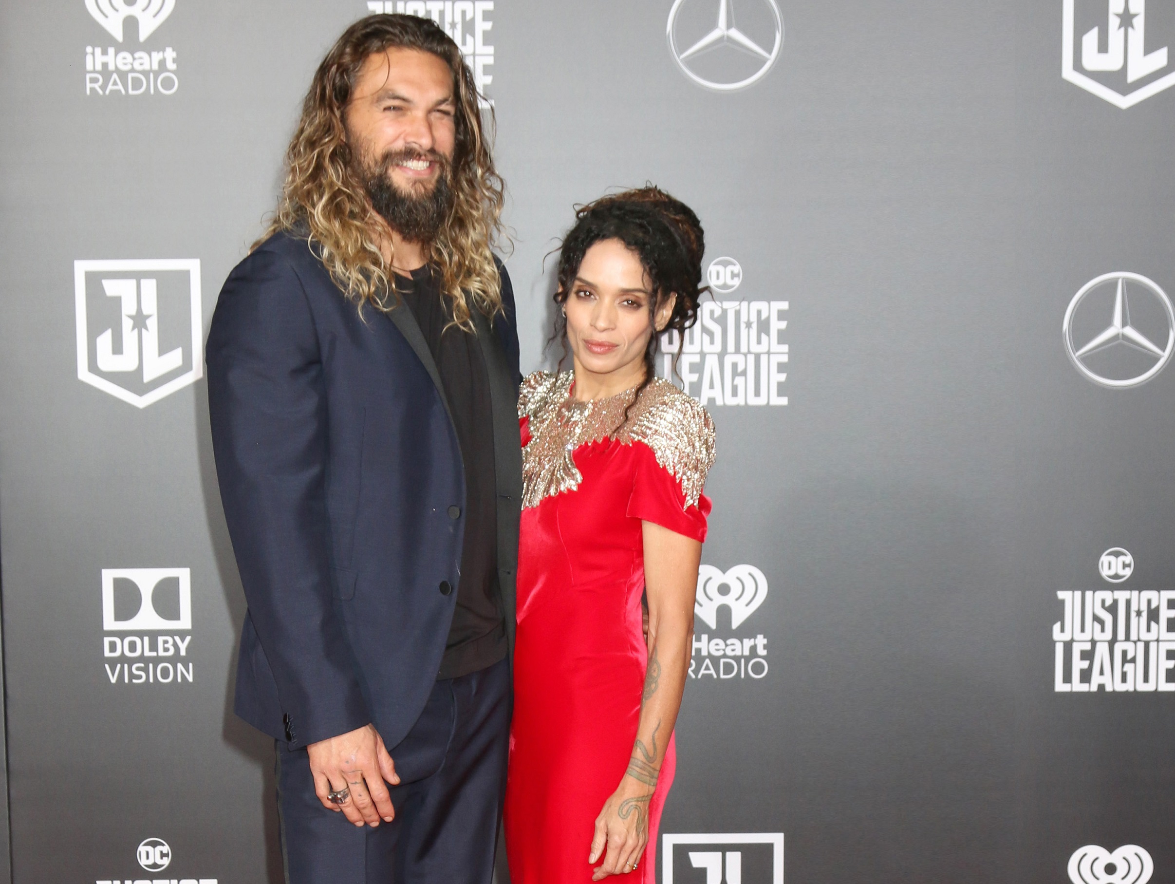 Jason Momoa in dark suit and Lisa Bonet in red dress - 2017