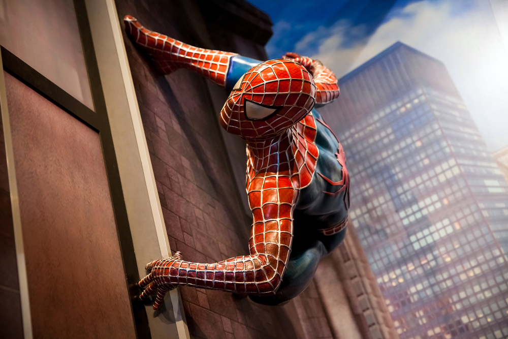 image of spiderman hanging on a building