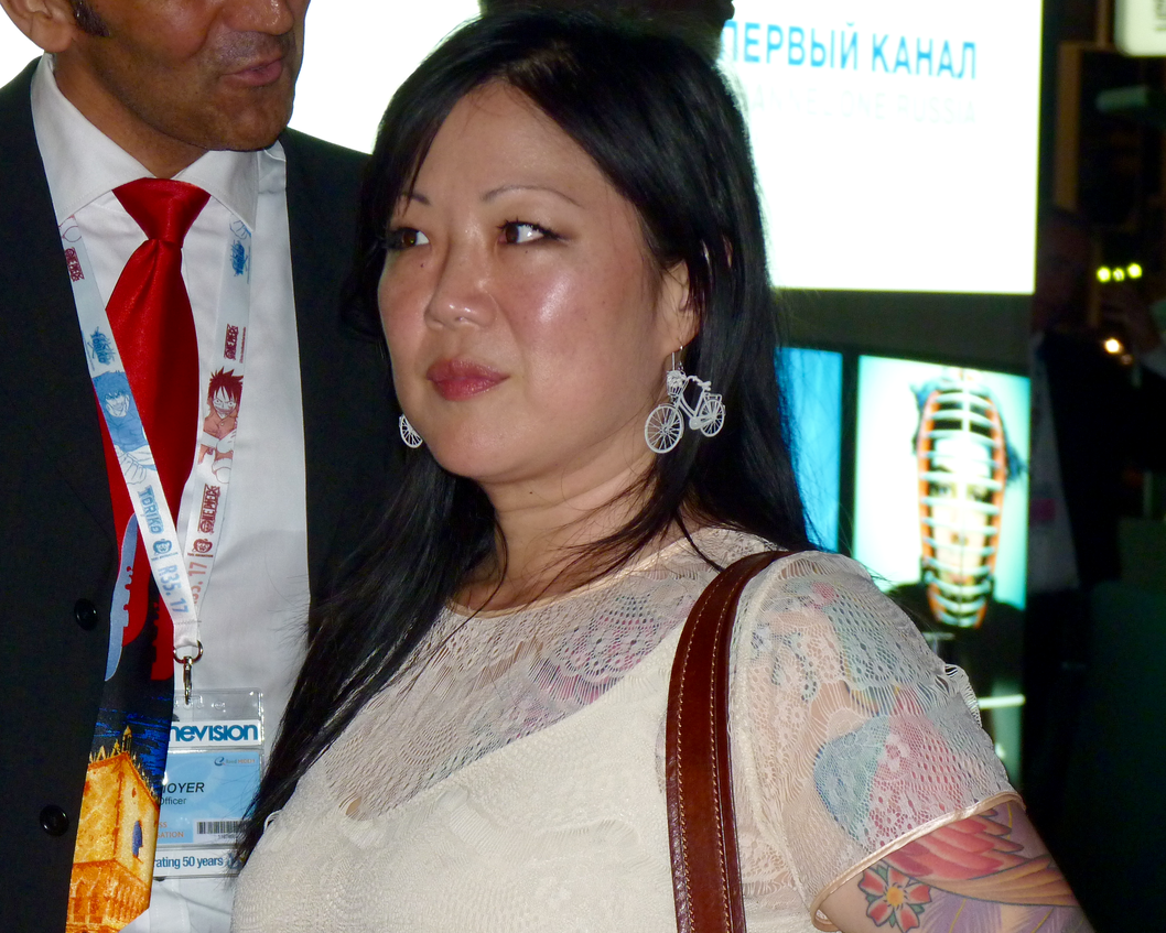 Portrait Photo of of the comedian Margaret Cho in a white dress
