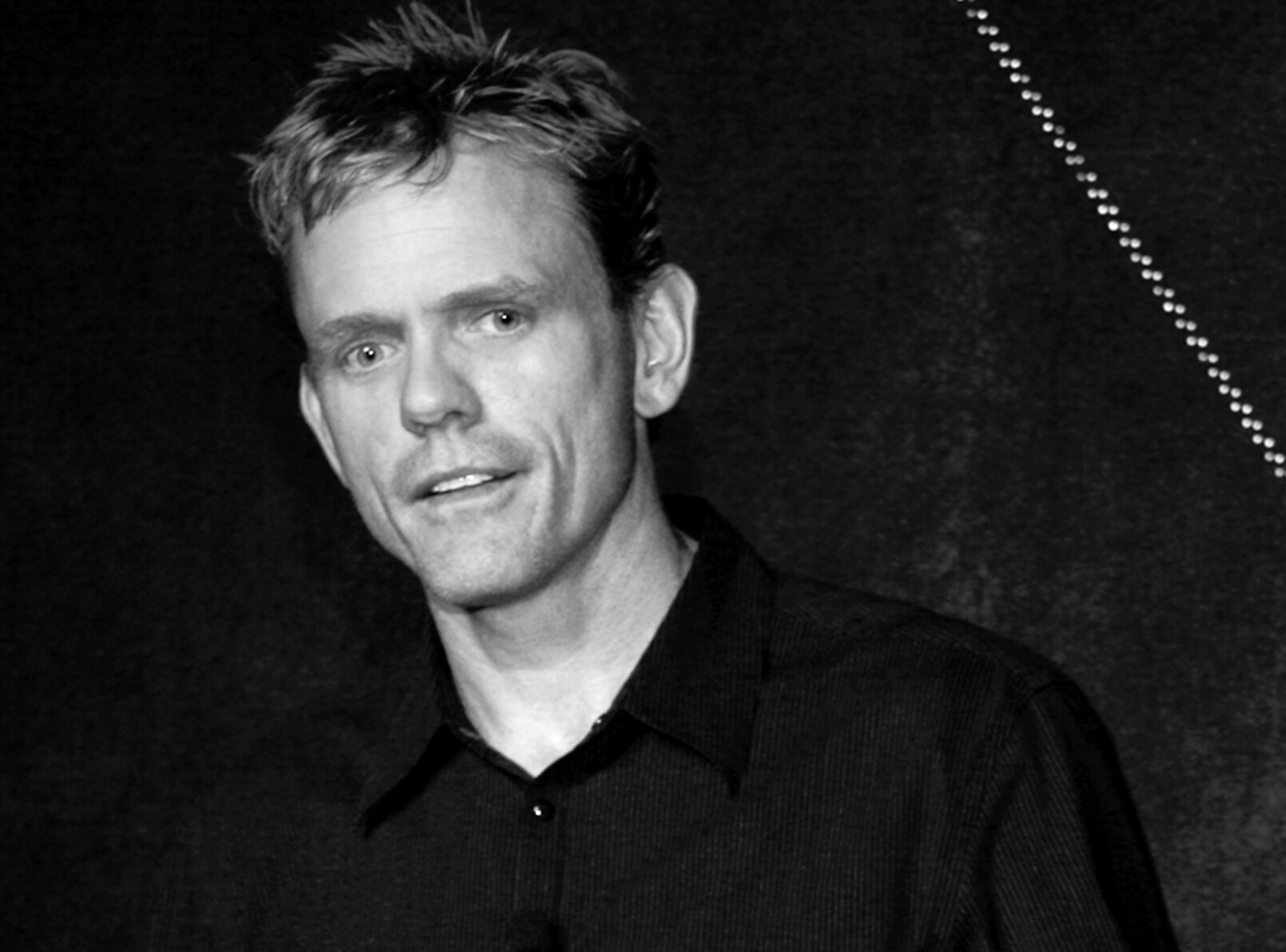 Grayscale Portrait Photo of the comedian Christopher Titus in a dark shirt